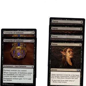 May include: Two Magic: The Gathering cards, Cartouche of Ambition and Duress. Cartouche of Ambition is a gold and blue enchantment card with a golden cartouche design. Duress is a black sorcery card with a black and white illustration of a woman with thorns in her face.