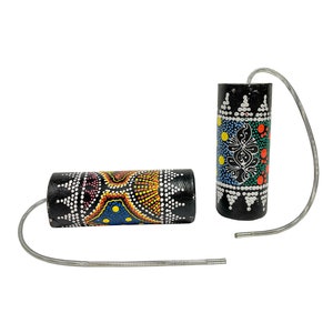 May include: Two black rainsticks with colorful dot art designs. One is horizontal, the other vertical, connected by a silver spring. The rainsticks feature patterns in yellow, blue, red, and white.