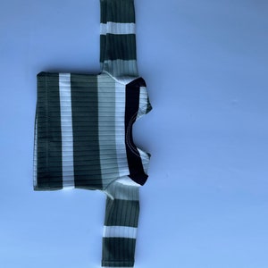 May include: A long-sleeved shirt with white and green stripes and a black collar.