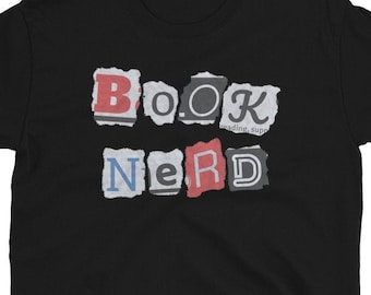 May include: Black t-shirt with the words "BOOK NERD" in a distressed, torn paper style font.