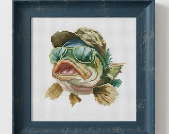 May include: Cross-stitch art of a fish wearing sunglasses and a hat, set in a distressed blue frame. The fish has a detailed design with shades of green, tan, and pink. The sunglasses are green, and the hat is camouflage.