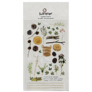 May include: A sheet of clear stickers with a woodland theme. The stickers feature pine cones, branches, leaves, a basket, and a wooden log. The sheet is labeled "Suatelier stickers no. 10188: do some garden".