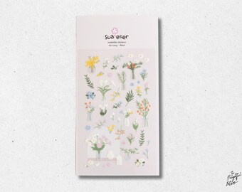 May include: A rectangular sheet of Suatelier stickers, no. 1124 fleur, featuring various small illustrations of flowers in vases, individual stems, and greenery in shades of yellow, blue, orange, white, and green on a light background.