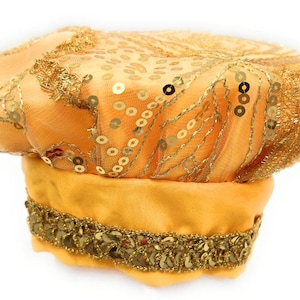 May include: A golden yellow hat featuring a structured base with a wide band of metallic gold sequins. The top section is crafted from sheer mesh fabric adorned with intricate gold thread embroidery and scattered gold sequins throughout the surface.