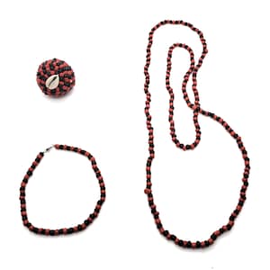 May include: A set of three necklaces made with red and black beads. The necklaces are of varying lengths. The shortest necklace is a choker, the middle necklace is a shorter chain, and the longest necklace is a long chain.