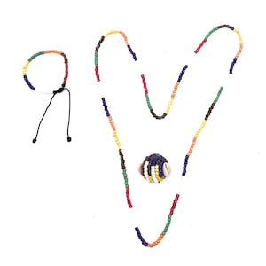 May include: A set of colorful beaded jewelry, including a necklace, bracelet, and a small beaded ball charm. The necklace and bracelet are made with multi-colored beads, including red, orange, yellow, green, blue, and brown.