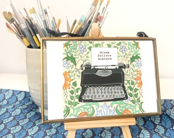 Brass framed giclee print of vintage black typewriter with quote ‘Dream Believe Achieve’