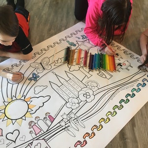 Könnte beinhalten: Drei Kinder färben ein großes, weißes, ausgeklapptes Malblatt mit einem Regenbogen, einer Sonne, Wolken, Blumen, einem Gebäude und Fußabdrücken. Das Blatt liegt auf einem Holzboden. Die Kinder benutzen farbige Stifte.