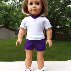 Made for 18 Inch Size Dolls, White T-Shirt Purple Neckline, Purple Shorts, with Purple Slip-On Sneakers.