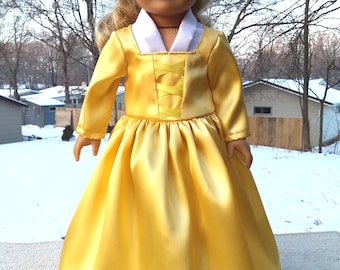 May include: A yellow satin dress with a white collar and a yellow ribbon detail. The dress is worn by a doll with blonde hair and blue eyes.