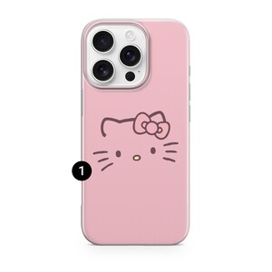 May include: Pink phone case featuring a Hello Kitty design. The case has a clear border and a cartoon illustration of Hello Kitty's face. The phone case is designed to fit a smartphone.