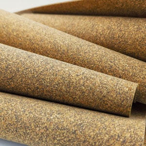 May include: Close-up of a stack of cork sheets, showing the natural texture and color variations of the material.
