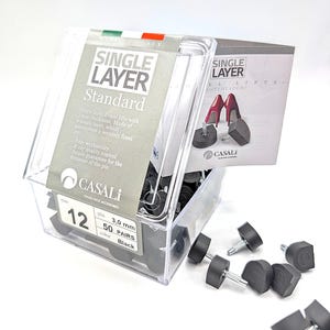 May include: A clear plastic box containing black shoe heel lifts. The box has a label that reads "SINGLE LAYER Standard" and "CASALI Italian Shoe Accessories." The label also indicates the size, pin, and color of the lifts.