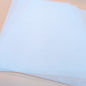 May include: A stack of light blue tissue paper.
