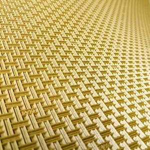 May include: A close-up of a gold-coloured textured surface with a repeating pattern of woven squares.