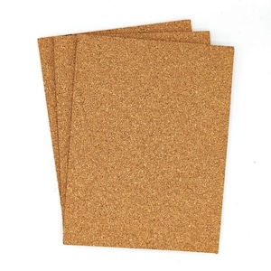May include: Three rectangular cork sheets, stacked slightly, showcasing a natural, textured surface. The cork has a warm, light brown color, and the sheets are arranged against a white background.
