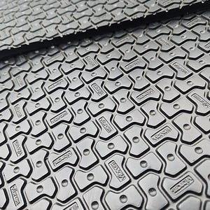 May include: Close-up of a black rubber mat with a repeating pattern of small, raised, star-shaped bumps. The mat has the word "Microfiber" embossed on each bump.