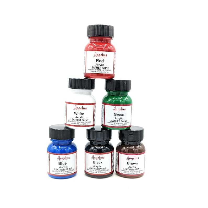 May include: Six bottles of Angelus acrylic leather paint in the colors red, white, green, blue, black, and brown. Each bottle is labeled with the color and the brand name.