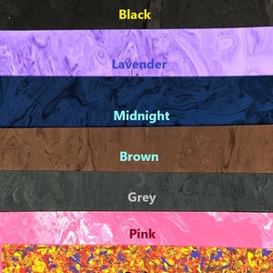 May include: A set of ten colorful marbled plastic sheets in various colors, including blue, black, lavender, midnight blue, brown, grey, pink, red, and yellow. The sheets are arranged vertically, with the color names written in red below each sheet.