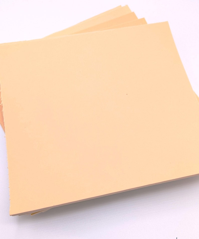 May include: A stack of light peach colored craft paper sheets.