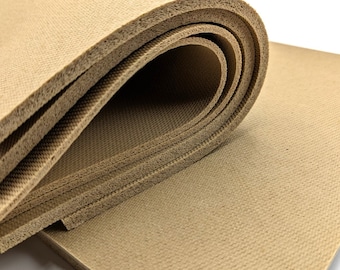 May include: A close-up of a brown foam sheet, rolled up and showing the layers of the material.