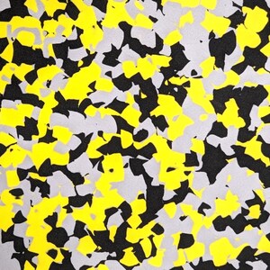 May include: Abstract pattern with black, yellow, and gray shapes. The shapes are irregular and resemble a camouflage pattern.