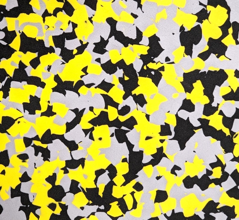 May include: Abstract pattern with black, yellow, and gray shapes. The shapes are irregular and resemble a camouflage pattern.