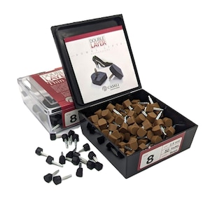 May include: A box of 50 pairs of beige double layer heel lifts, size 8. The box is open and the heel lifts are visible. The heel lifts are 2.5 mm thick. The box is labeled "Double Layer Heel Lifts" and "Casali".