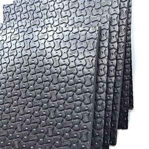 May include: A stack of six black foam mats with a textured surface. The mats have a repeating pattern of small, raised hexagons.