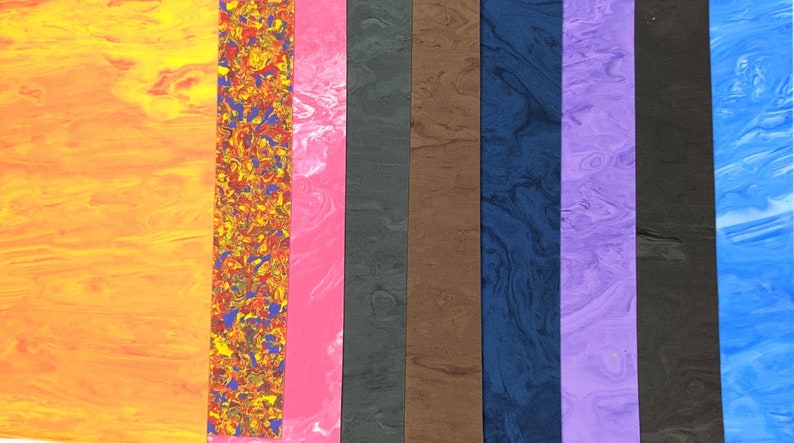 May include: Assortment of 10 different colors of marbled plastic sheets. The colors include orange, red, pink, black, brown, blue, purple, and light blue.