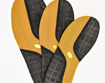 May include: Three brown and black shoe insoles with a grid pattern. The insoles are made of a soft, flexible material and are designed to provide comfort and support.