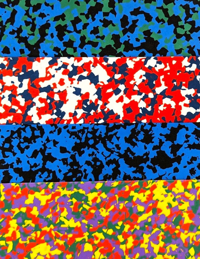 May include: Four horizontal strips of fabric with a camouflage pattern. The top strip is blue, green, and black. The second strip is red, white, and black. The third strip is blue and black. The bottom strip is yellow, red, green, purple, and black.