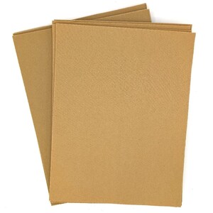 May include: A stack of three brown cardstock sheets. The sheets have a subtle textured surface.