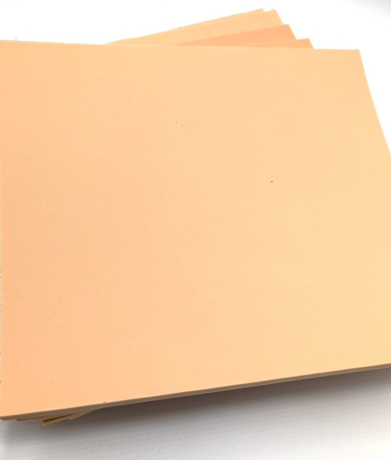 May include: A stack of peach-colored craft foam sheets.