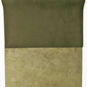 May include: A piece of dark green leather with a lighter green suede backing.