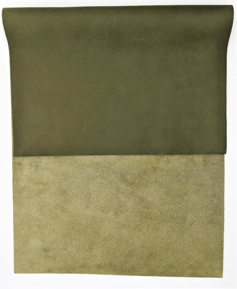 May include: A piece of dark green leather with a lighter green suede backing.