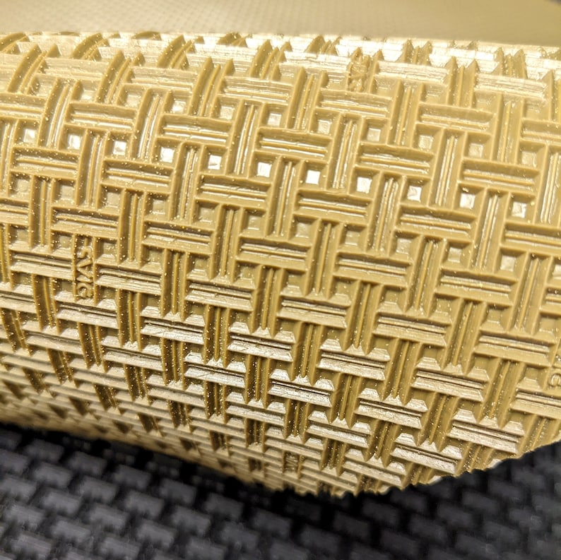 May include: Close-up of a brown textured rubber mat with a grid pattern. The mat has a raised surface with a subtle sparkle.