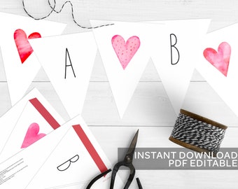 May include: Printable banner with pink watercolor hearts and letters A and B. The banner is on a white wooden background with a spool of twine and scissors. The text "INSTANT DOWNLOAD PDF EDITABLE" is at the bottom of the image.