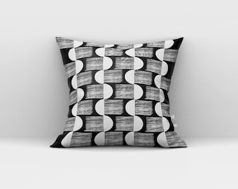 May include: Black and white geometric pillow with a repeating pattern of circles and stripes.