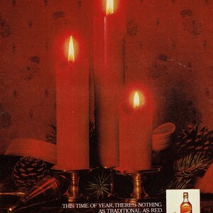 May include: An advert showing three lit red candles on a decorative stand. The text reads "THIS TIME OF YEAR, THERE'S NOTHING AS TRADITIONAL AS RED." A bottle of Johnnie Walker Red is also shown.