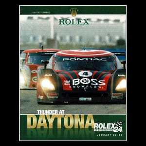 May include: An advertisement for the Rolex 24 at Daytona race. The image features a red and black race car with the number 4, sponsored by Boss Snowplow and Pontiac. The Rolex logo is at the top, with the race details at the bottom.
