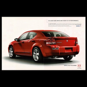 May include: A red Dodge Avenger sedan is shown from a rear three-quarter view. The car has silver wheels and a black interior. Text on the image reads "ITS 20GB HARD DRIVE ONLY ADDS TO ITS PERFORMANCE" and "GRAB LIFE BY THE HORNS."