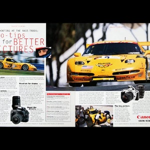 May include: A yellow race car with the number 2 on the side, driving on a race track. The car has the words "Good Year" on the tires and "Bulls Eye" on the side. The image is from a magazine article about how to take better pictures at a race track. The article includes tips like "Make a plan", "Pan for action", "Zoom for drama", and "Shoot the drivers". The article also features a Canon camera.