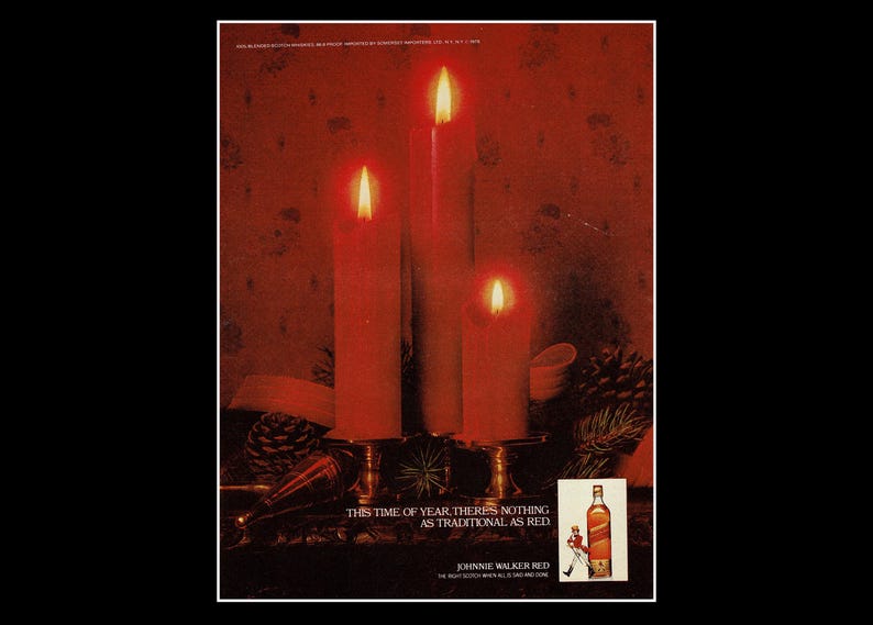 May include: An advertisement showing three lit red candles on a decorative stand. The text reads "THIS TIME OF YEAR, THERE'S NOTHING AS TRADITIONAL AS RED" with a bottle of Johnnie Walker Red.