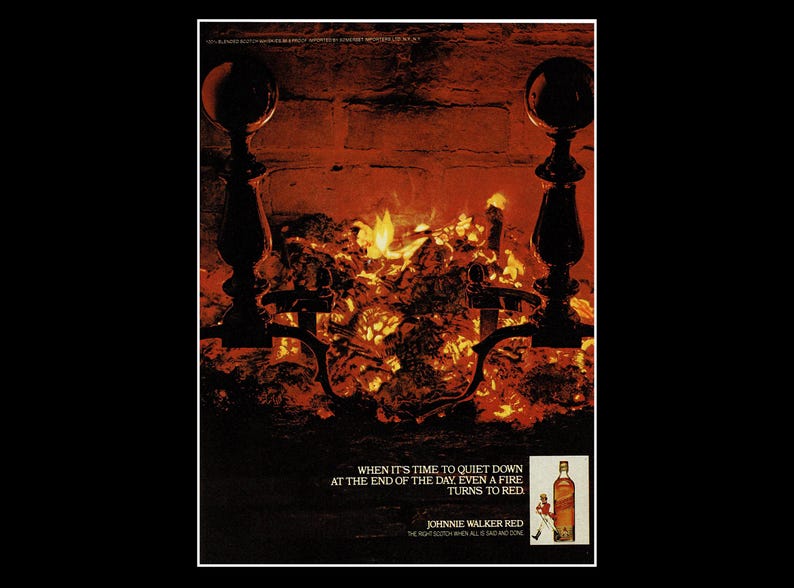 May include: Vintage advertisement featuring a fireplace with a burning fire. The image includes a bottle of Johnnie Walker Red Scotch and the text: "When it's time to quiet down at the end of the day, even a fire turns to red."
