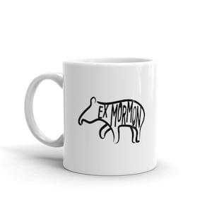 May include: White ceramic coffee mug with a black outline of a tapir with the words "Ex Mormon" written inside the outline.