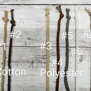 May include: An overhead shot displays six different cords against a light wood background. The cords are labeled with numbers and material types: cotton, polyester, and jute. The cords vary in color from light tan to dark brown and gray.