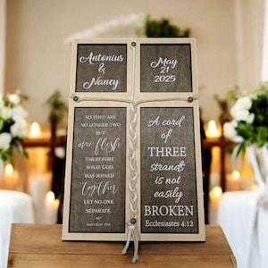 May include: A wooden sign with a braided rope design, featuring the names Antonius & Nancy, the date May 21, 2025, and the text "So they are no longer two but one flesh... A cord of three strands is not easily broken."  The text is from the Bible, Matthew 19:6 and Ecclesiastes 4:12.