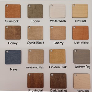 May include: A collection of wooden square color samples, each with a small hole for hanging. Colors include Gunstock, Ebony, White Wash, Natural, Honey, Special Walnut, Cherry, Light Walnut, Navy, Weathered Oak, Golden Oak, Weathered Gray, Provincial, Dark Walnut, and Raw Maple.