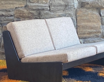 1970's Carl Straub black oak loveseat with new wool upholstery